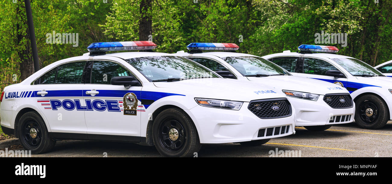 Laval, Canada: May 19, 2018. Police cars parked in the parking area of the public park. A lot of police cars stationed in line. Stock Photo