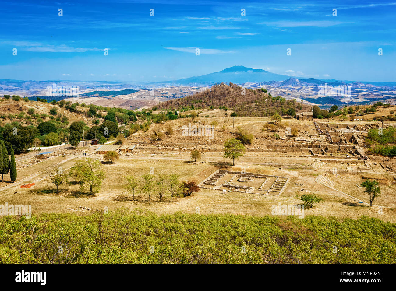 Greek theater with other ruins of old town in Morgantina archaeological site, Sicily, Italy Stock Photo
