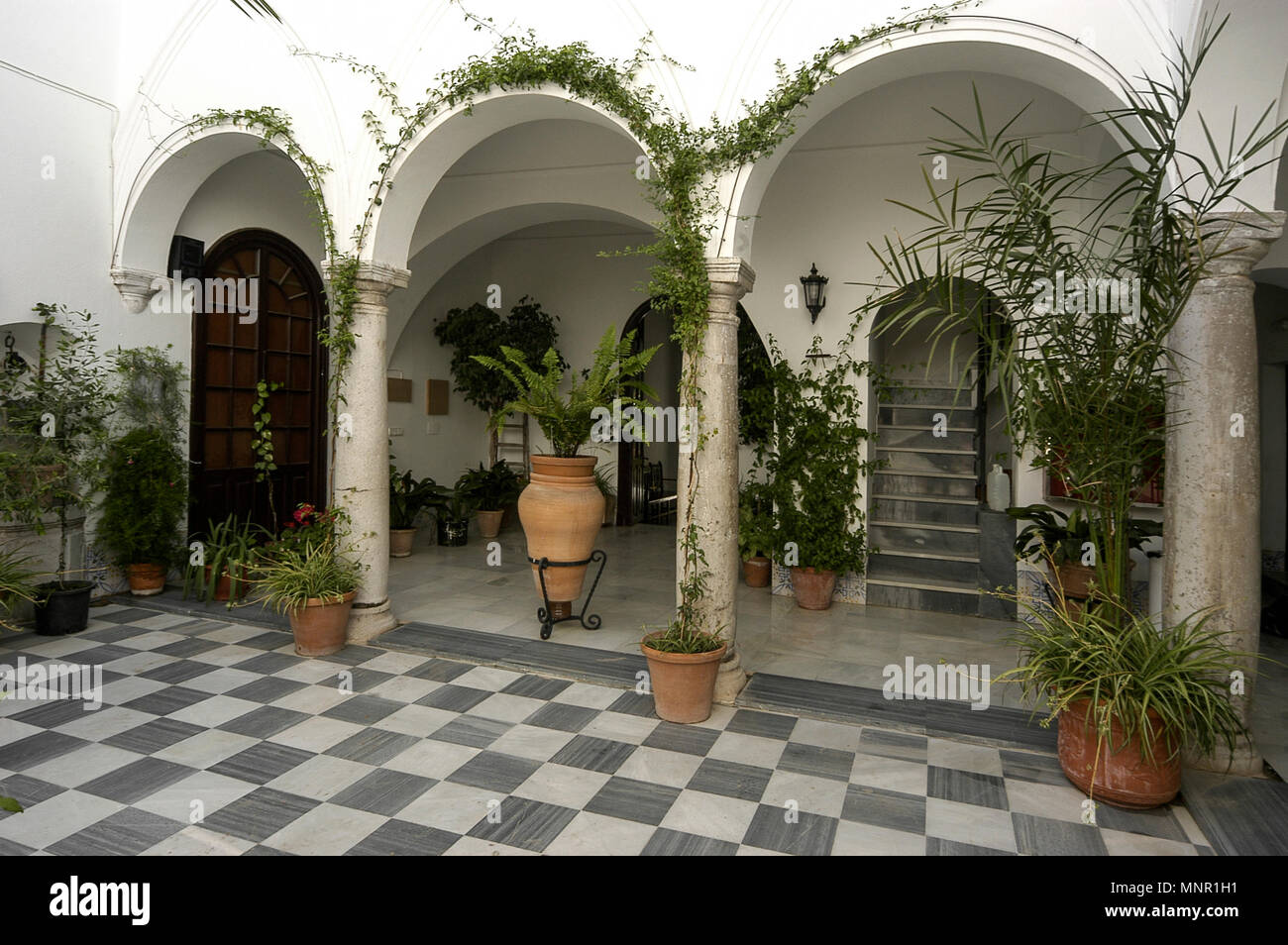 A large Spanish inner courtyard with Moorish architectural arches in a