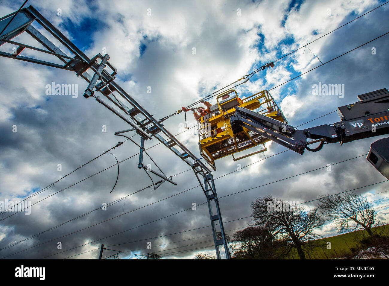 Railway workers working on overhead lines Stock Photo