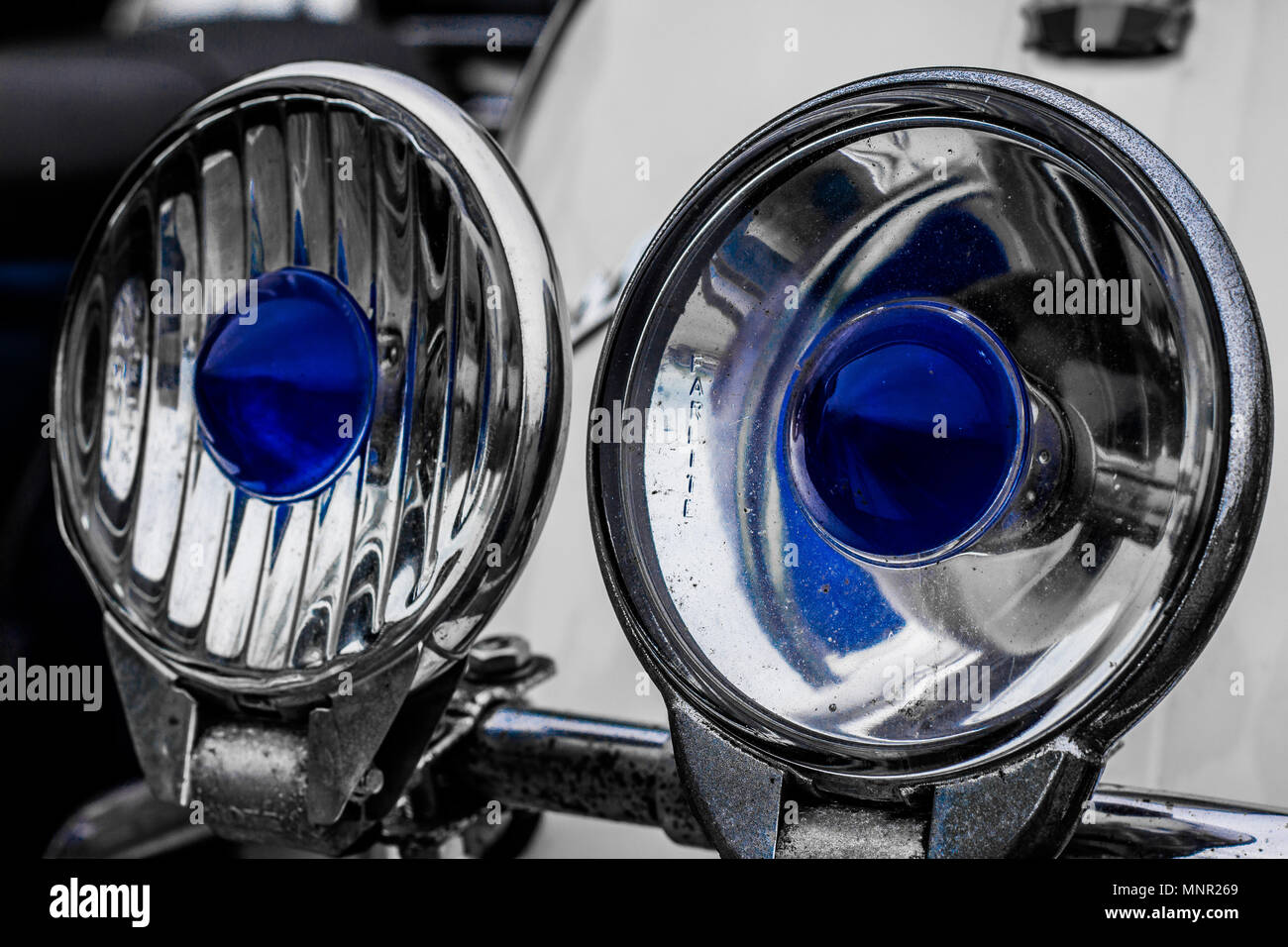 Close up of two headlights on a scooter with blue centres Stock Photo