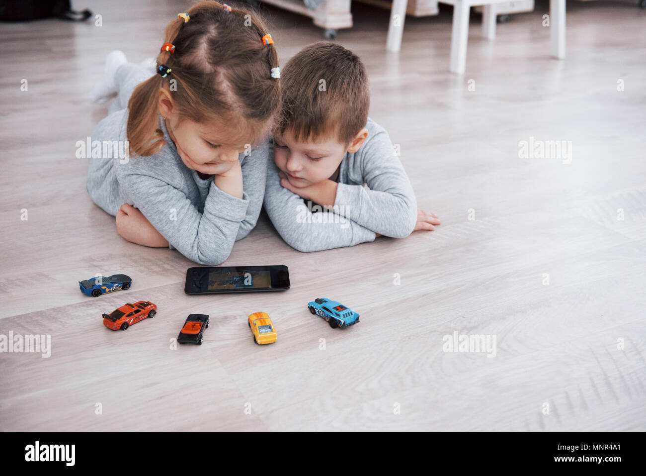 Children Using Digital Gadgets At Home Brother And Sister On Pajamas Watch Cartoons And Play Games On Their Technology Tablet Stock Photo Alamy