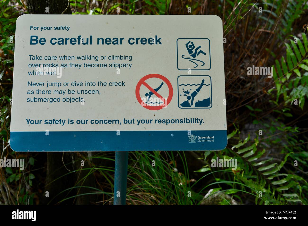 Be careful near the creek sign, Jourama Falls, Bruce Hwy, Yuruga QLD, Australia Stock Photo