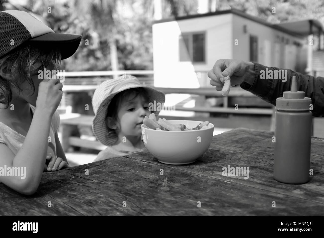 Australia children eat hot chips out of a bowl hires stock photography