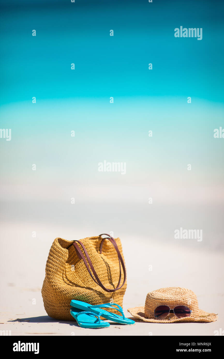 Straw hat, bag, sun glasses and flip flops on a tropical beach Stock ...