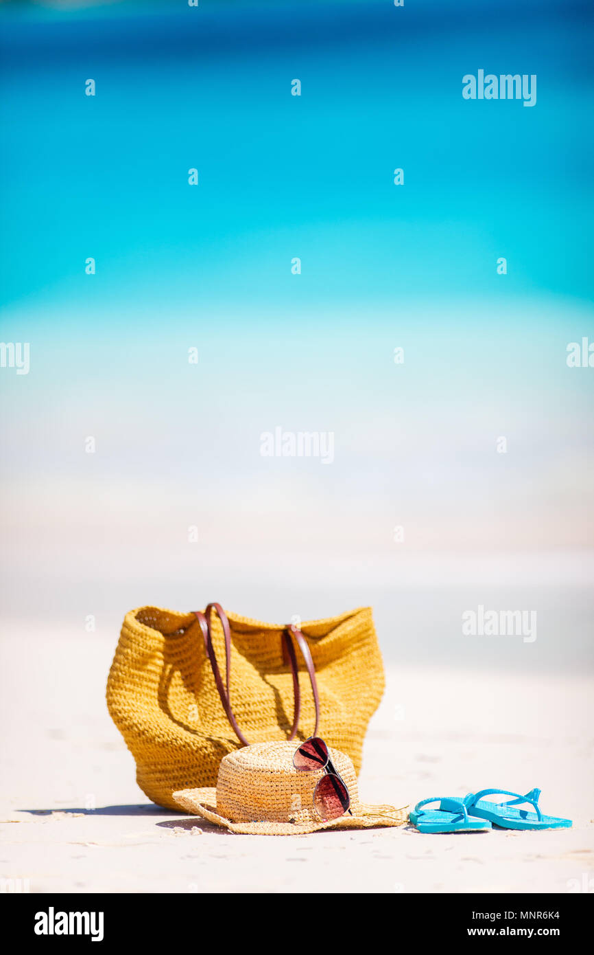Straw bag, sun glasses, towel and flip flops on a tropical beach Stock ...