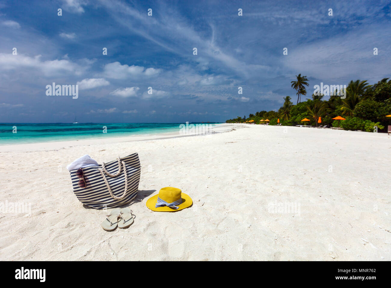 Straw hat, bag, sun glasses and flip flops on a tropical beach Stock ...