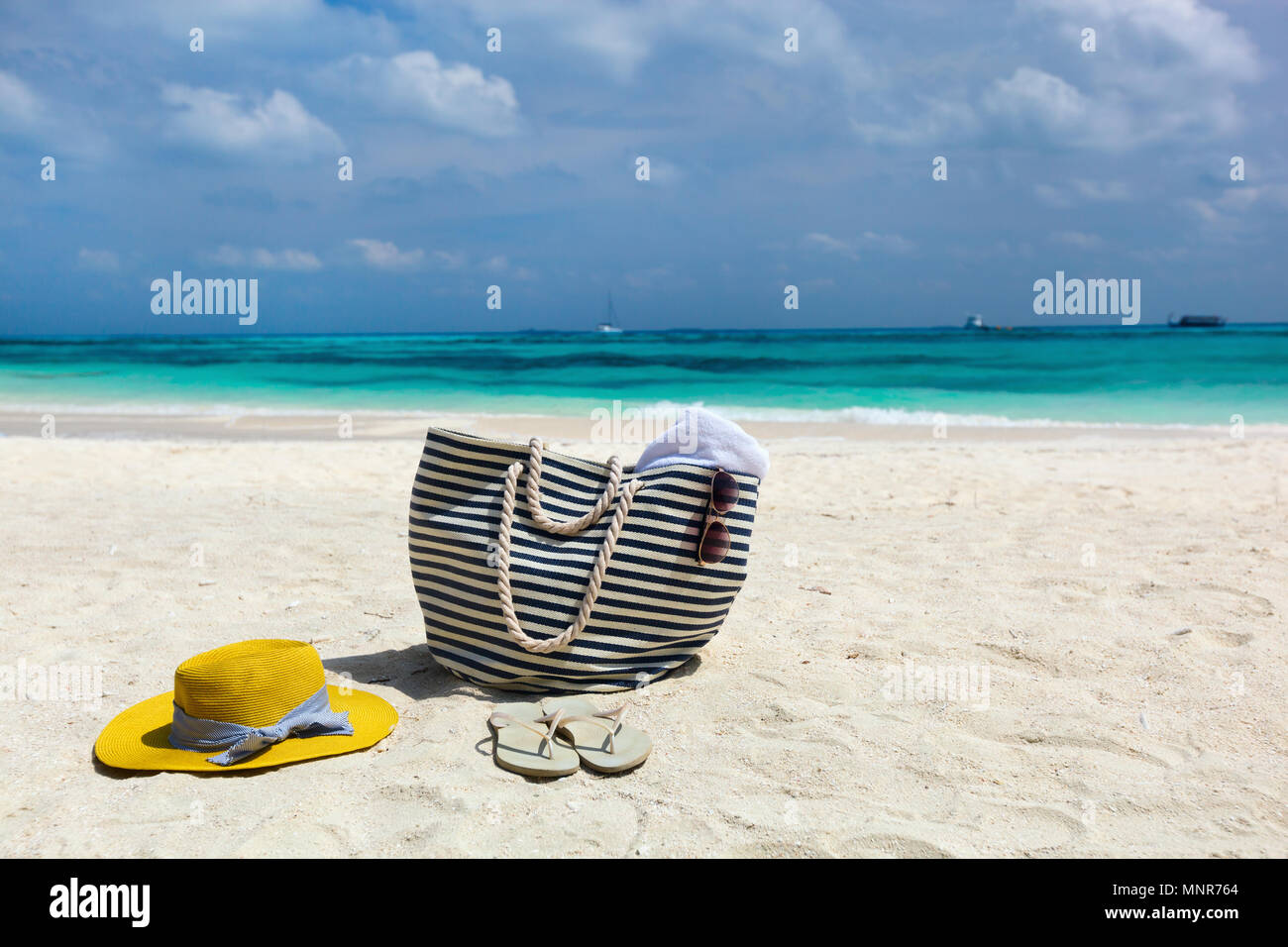 Straw hat, bag, sun glasses and flip flops on a tropical beach Stock ...