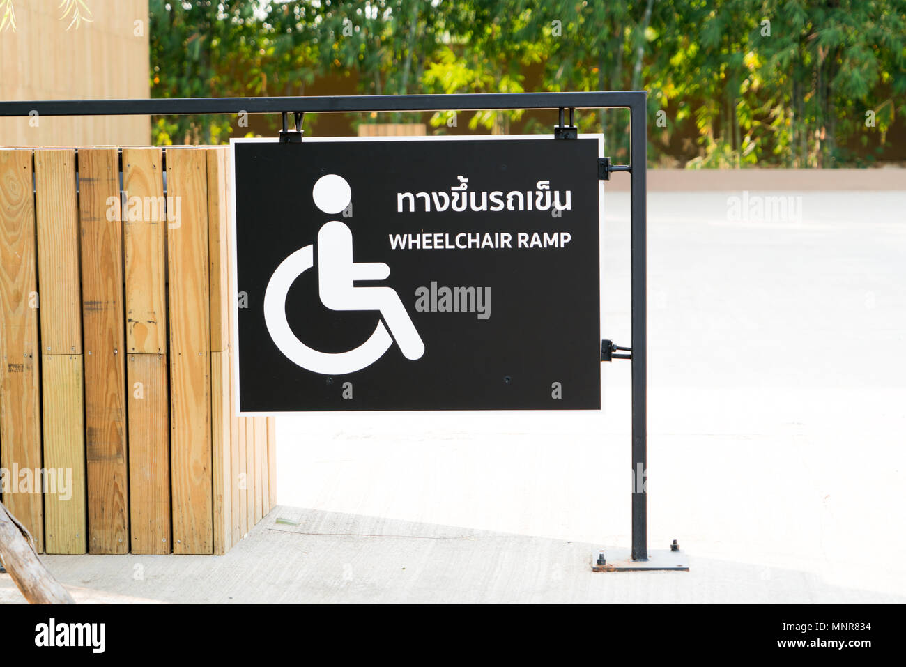 sign of wheelchair ramp on black plate - (ทางขึ้นรถเข็น = wheelchair ...