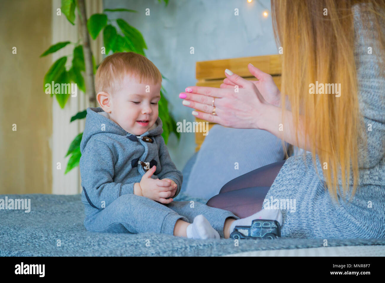 Happy young mother and her baby son playing togerher Stock Photo