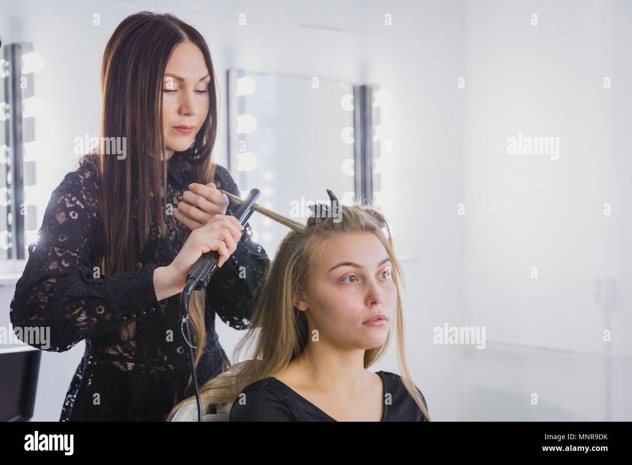 Beautiful Young Woman Is Getting Her Hair Straightened At Beauty