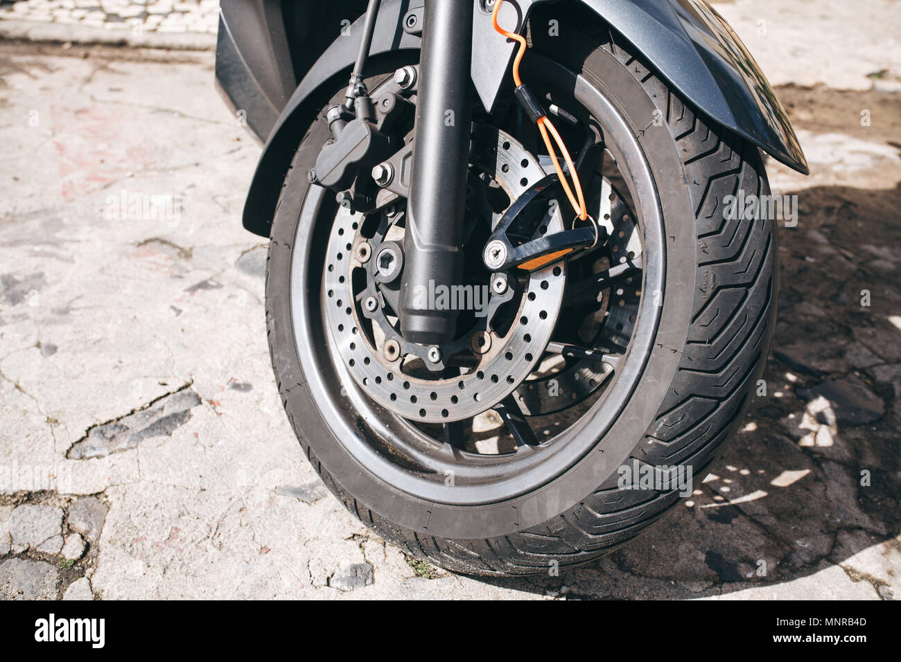 Wheel of motorcycle or scooter or moped. Autotire or tire and design of wheel of motorcycle. Brake system and spare parts for bike Stock Photo
