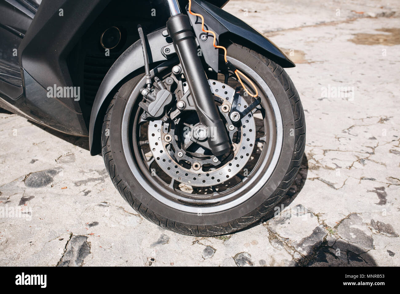 Wheel of motorcycle or scooter or moped. Autotire or tire and design of wheel of motorcycle. Brake system and spare parts for bike Stock Photo