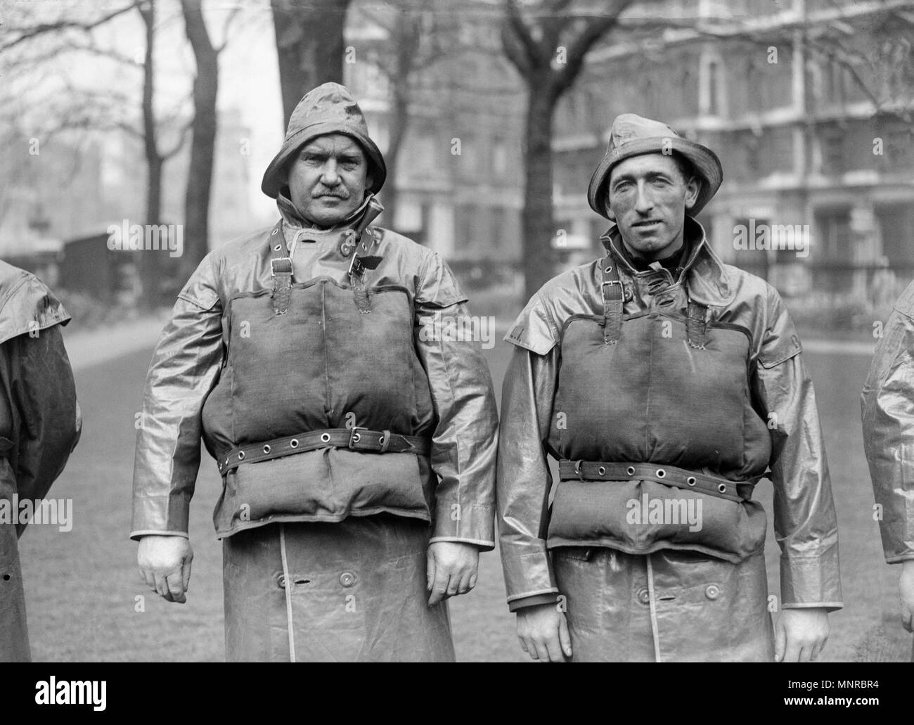 Vintage image of two lifeboatmen of the British Royal national Lifeboat Institution, or RNLI, showing the protective clothing used at the time. Image taken around the 1930s. Stock Photo