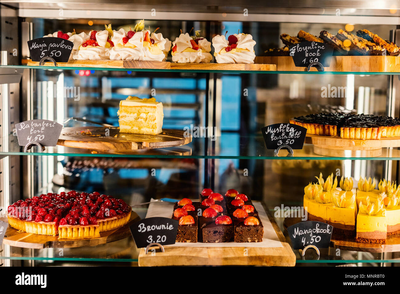 Pastry shop glass display with selection of sweets and cakes Stock