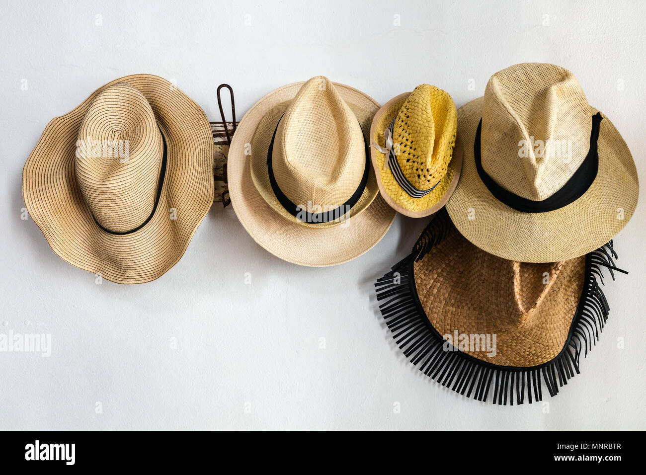 Straw hats on a rack Stock Photo Alamy