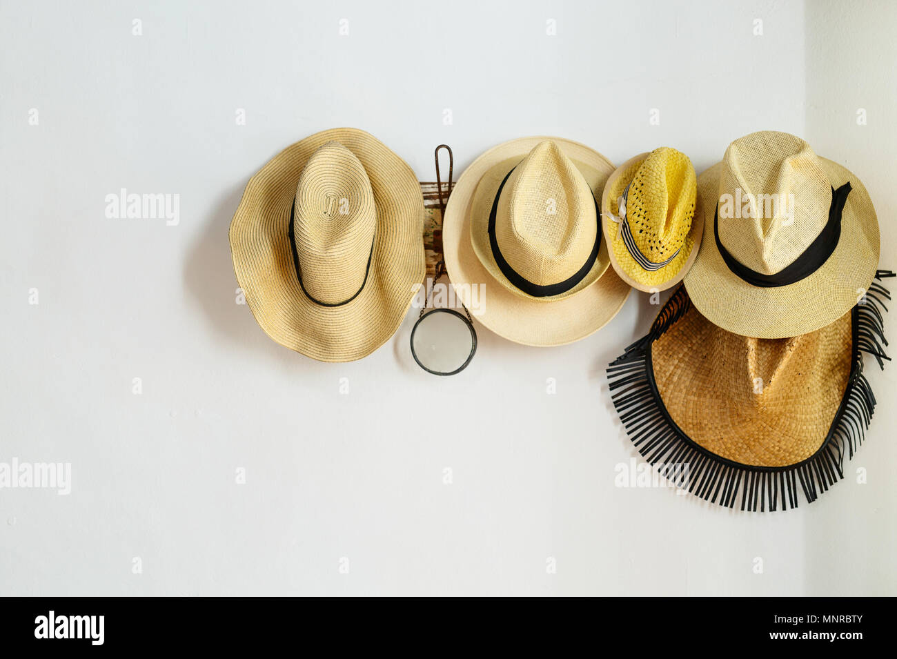 Straw hats on a rack Stock Photo - Alamy
