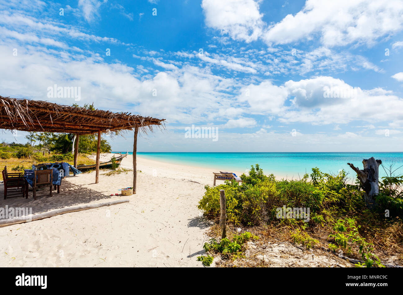 Idyllic tropical beach with white sand,  turquoise ocean water and blue sky in Mozambique Africa Stock Photo