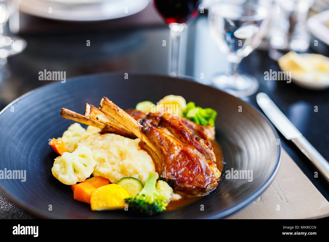 Delicious lunch or dinner with lamb cutlets and red wine in a