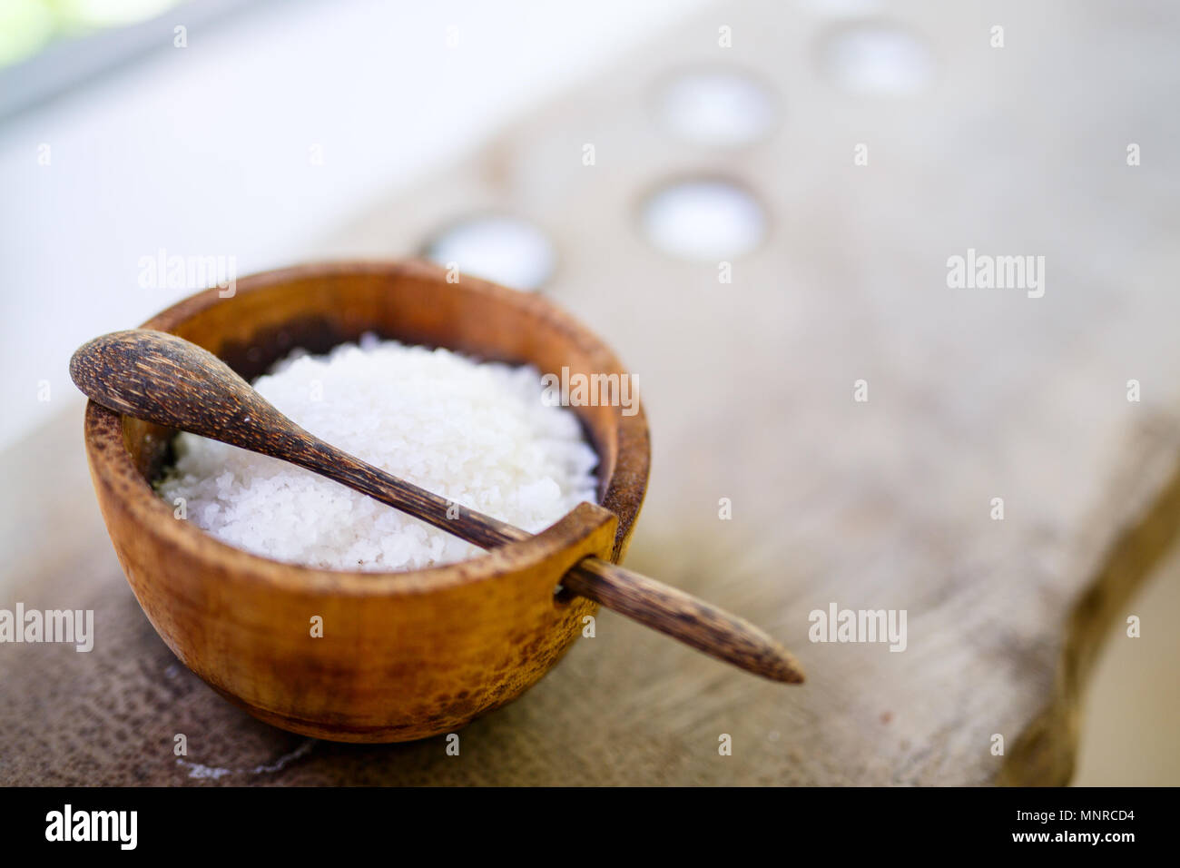 Bath salt in a wooden bowl in spa Stock Photo