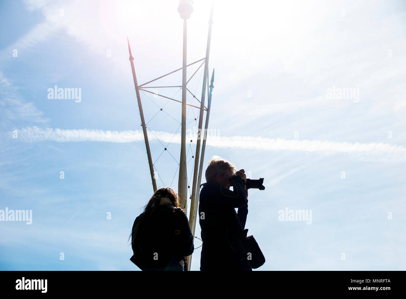 A woman takes a photograph outside Buckingham Palace Stock Photo