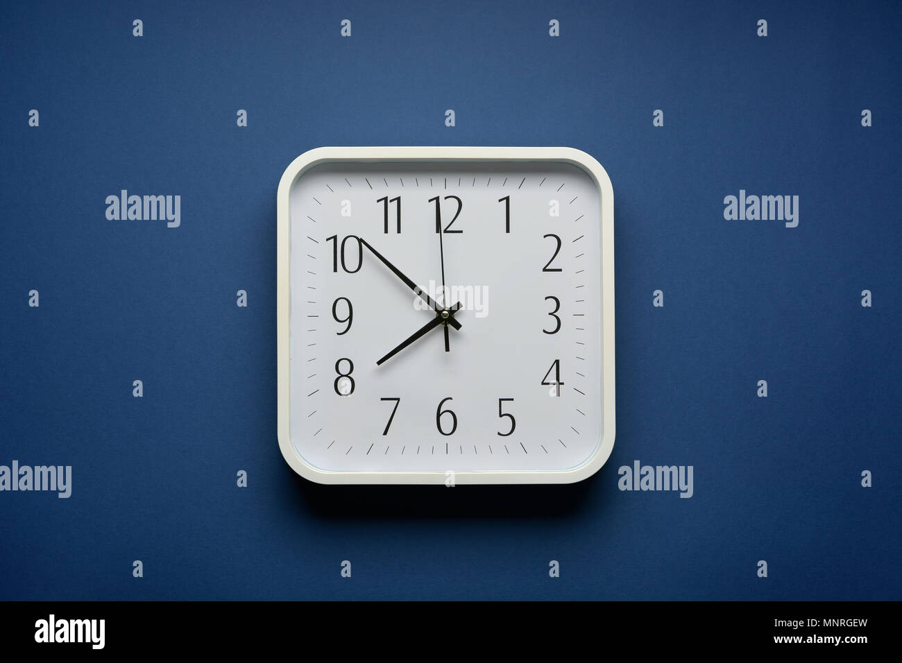 wall clock on the blue background - closeup Stock Photo - Alamy