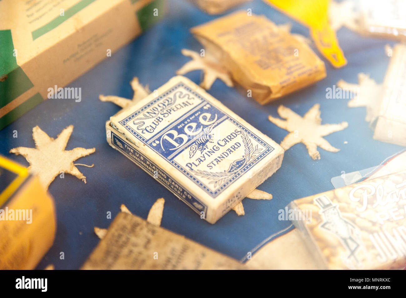 Daily things from World War II belongs to Battle of the Bulge Museum. A milk chocolate box, playing card, pop corn and cheeses. Stock Photo