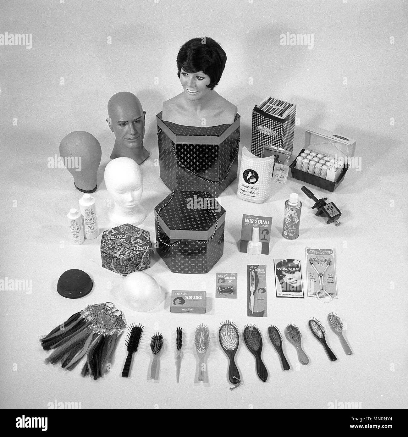 1960s, historical, picture shows a range of haircare products for looking after female wigs. It was in this era that a new type of synthetic wig was developed using a modacrylic fibre which made wigs more affordable and hence more popular. Stock Photo