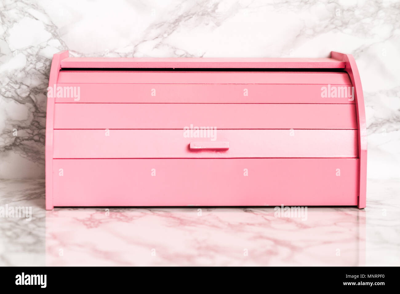 Pink wooden bread box on white marble background Stock Photo Alamy