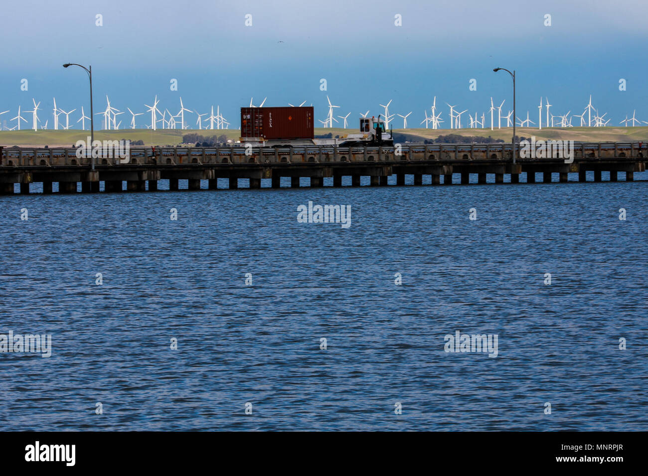 A U.S. Army Reserve Soldier transports a Twenty-foot equivalent unit container across a pier to a staging area during Operation Trans Mariner 18 West at Military Ocean Terminal Concord, California, Mar. 4, 2018. Trans Mariner 18 West is a real-world strategic mission utilizing U.S. Army Reserve  National Guard and Active component Soldiers to conduct Port Operations allowing Army materiel and munitions containers for travel onward. Stock Photo