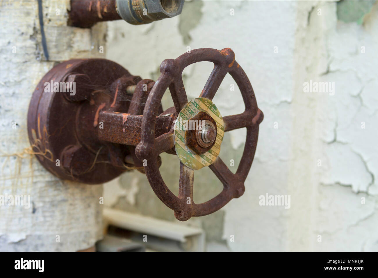 On old Italian valve located in a rundown naval shipyard. Stock Photo