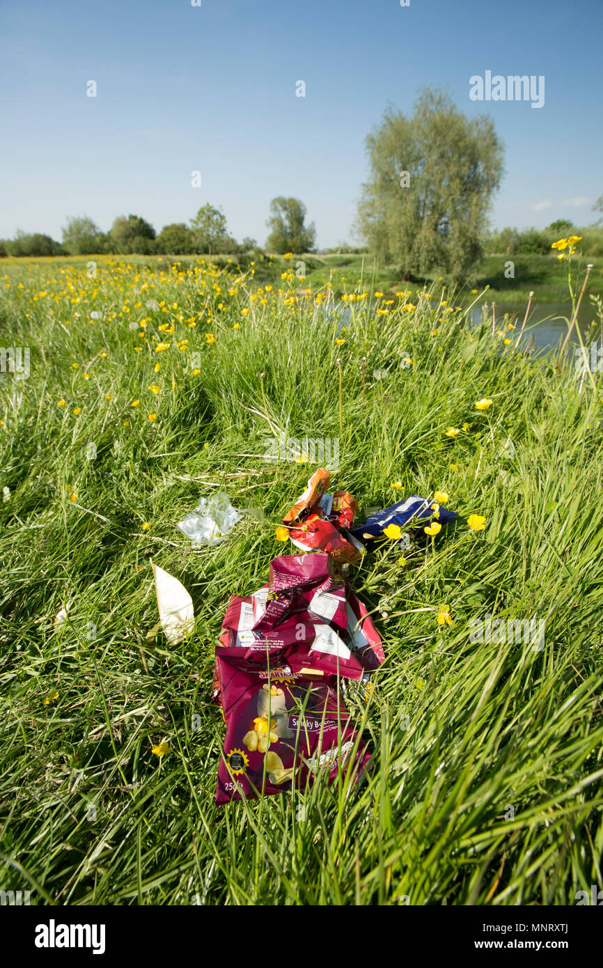 Litter left behind in a buttercup meadow adjacent to Fiddleford Mill pool on the Dorset Stour river near Sturminster Newton Dorset England UK GB. Stock Photo
