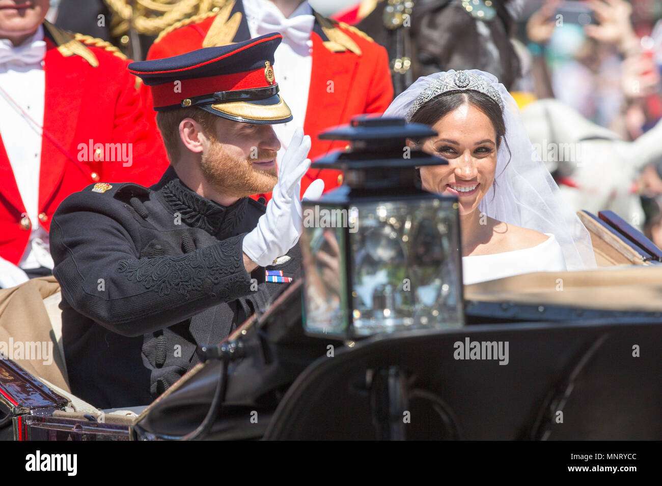 Picture dated May 19th shows Prince Harry and Meghan Markle greeting the crowds in Windsor on Kings Road after their wedding.   Prince Harry and Meghan Markle have been declared husband and wife, following a ceremony at Windsor Castle. The couple exchanged vows and rings before the Queen and 600 guests at St George's Chapel. Wearing a dress by British designer Clare Waight Keller, Ms Markle was met by Prince Charles, who walked her down the aisle. Following their marriage, the couple will be known as the Duke and Duchess of Sussex. Stock Photo
