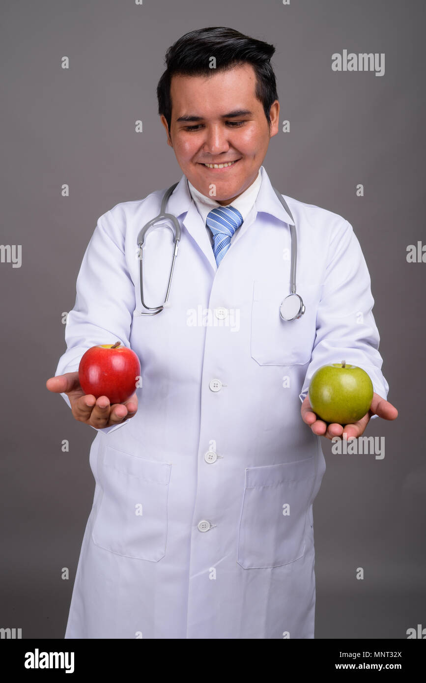 Happy asian man doctor thinking hi-res stock photography and images - Alamy