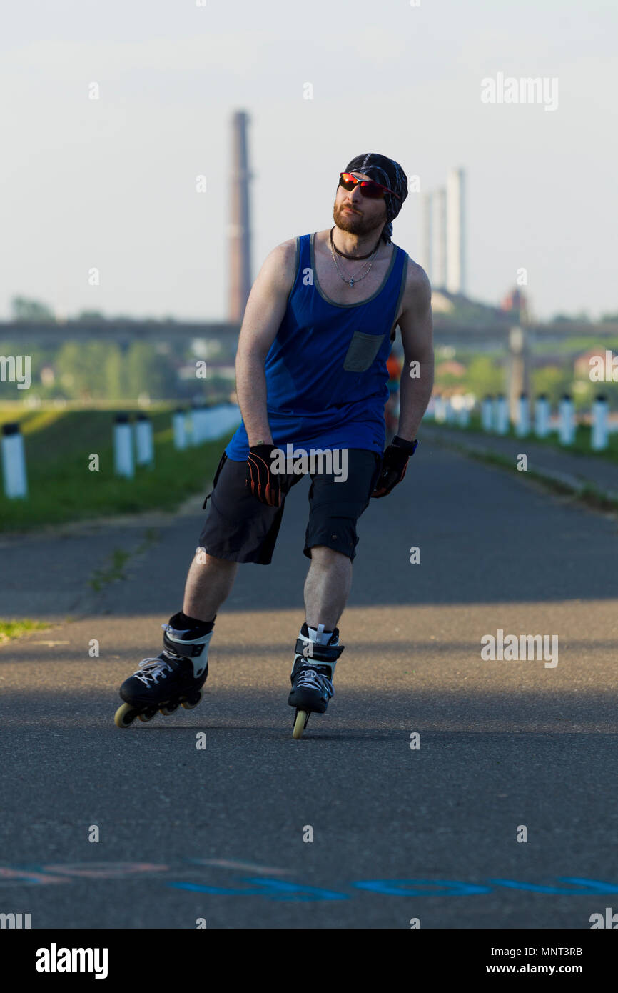 Roller Skates Riding Man riding on roller skates in the city, lit by natural light Stock ...
