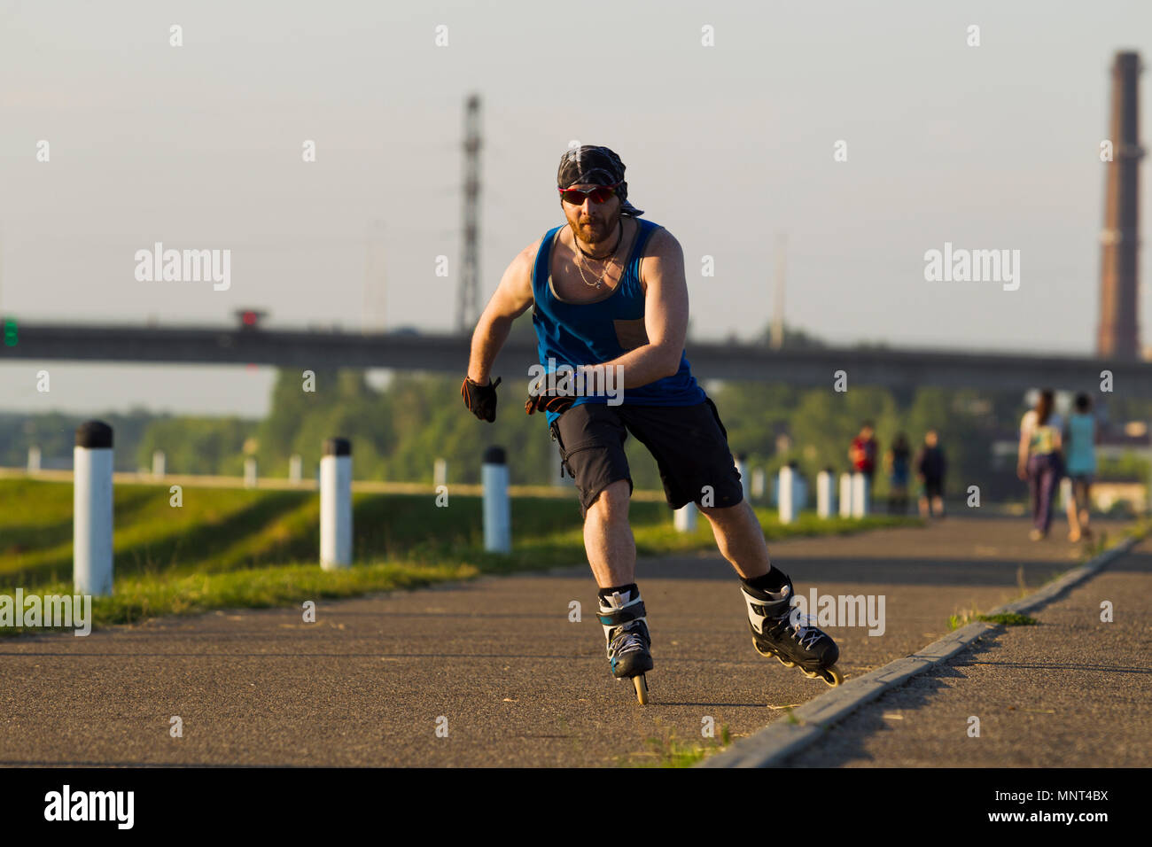 Roller Skates Riding Man riding on roller skates in the city, lit by natural light Stock ...