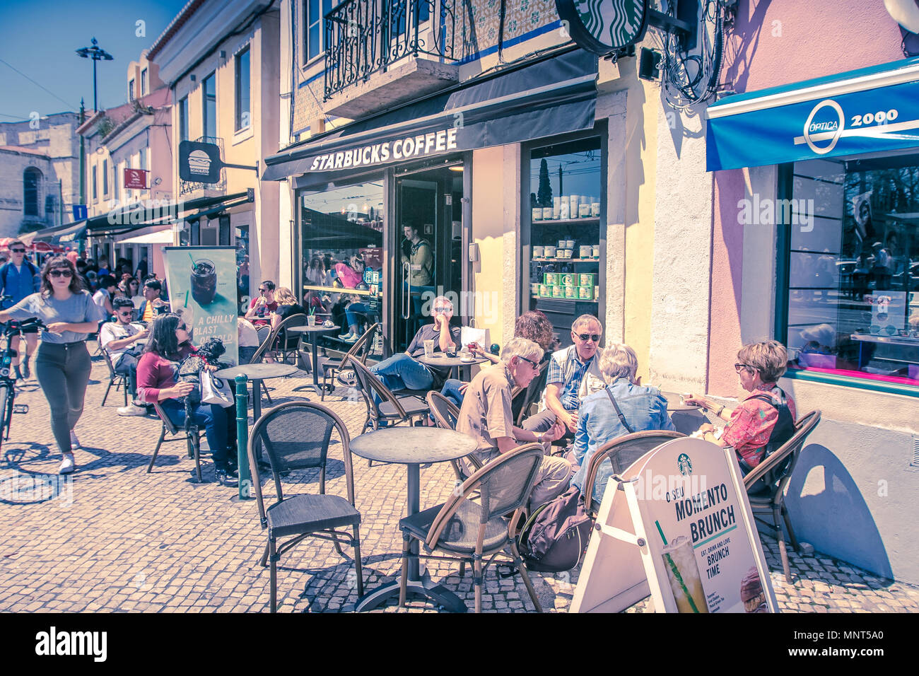 Lisbon, Portugal, May 5, 2018: Starbucks patrons are having coffee at sidewalk tables Stock Photo