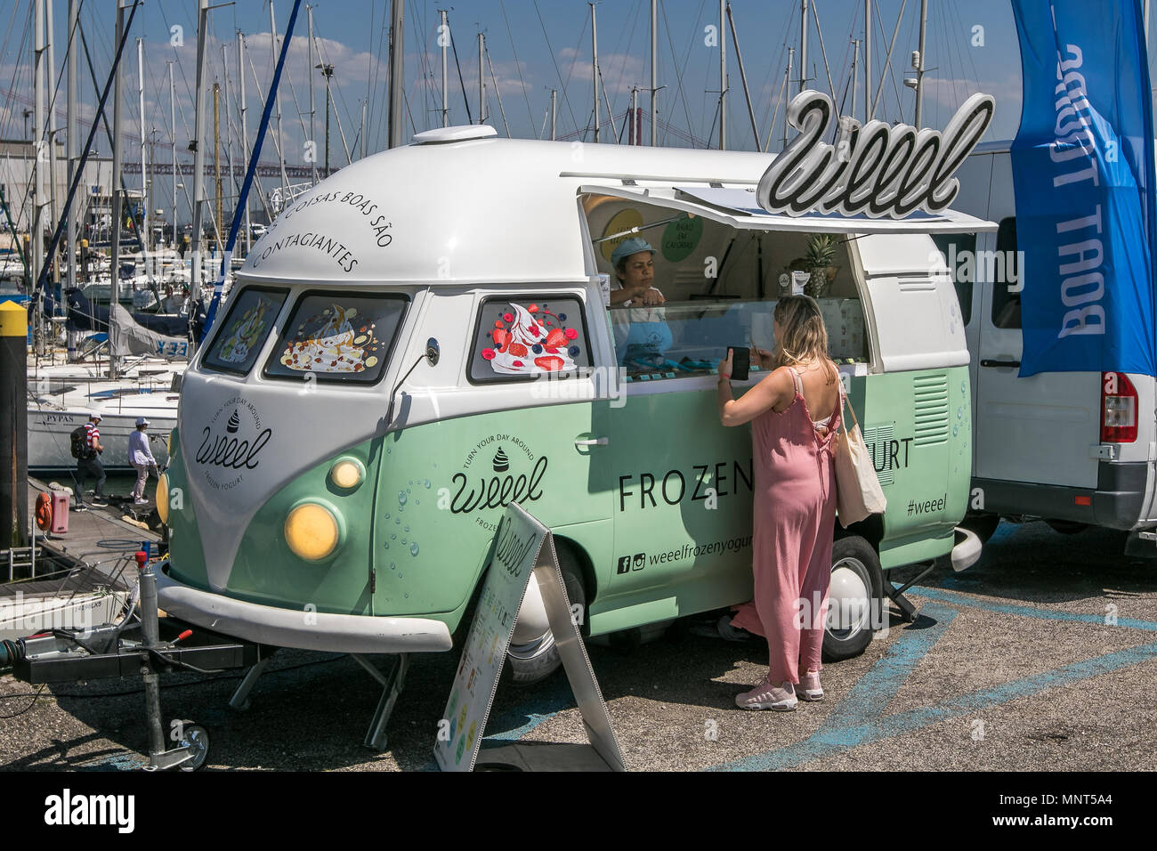 Lisbon, Portugal, May 5, 2018: Woman is buying something from a Weeel frozen yogurt truck at the square near Monument to the Discoveries. Stock Photo