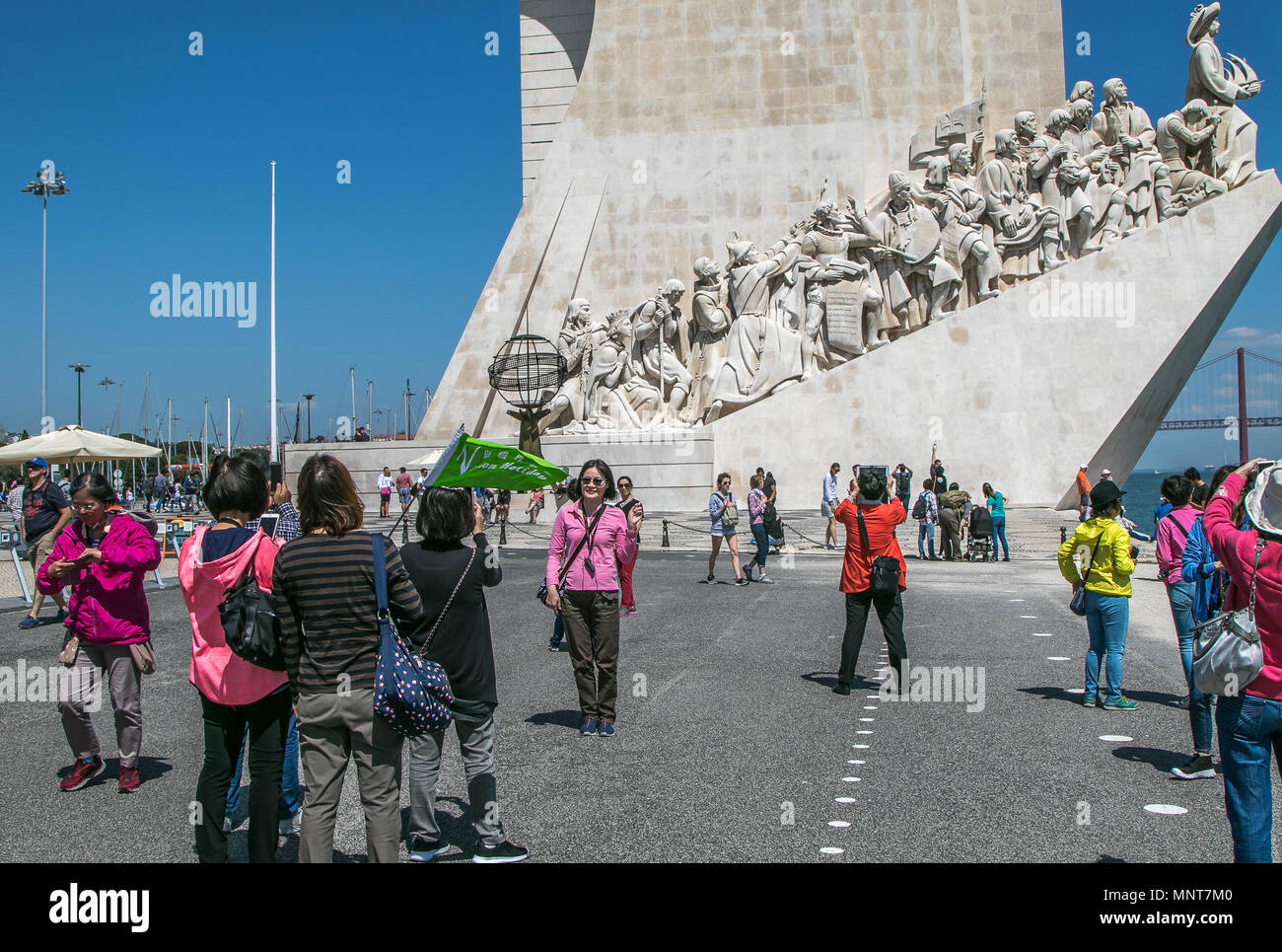 Asian tourists are taking pictures in front of the Monument to Discoveries in Belem, Lisbon, Portugal. Stock Photo