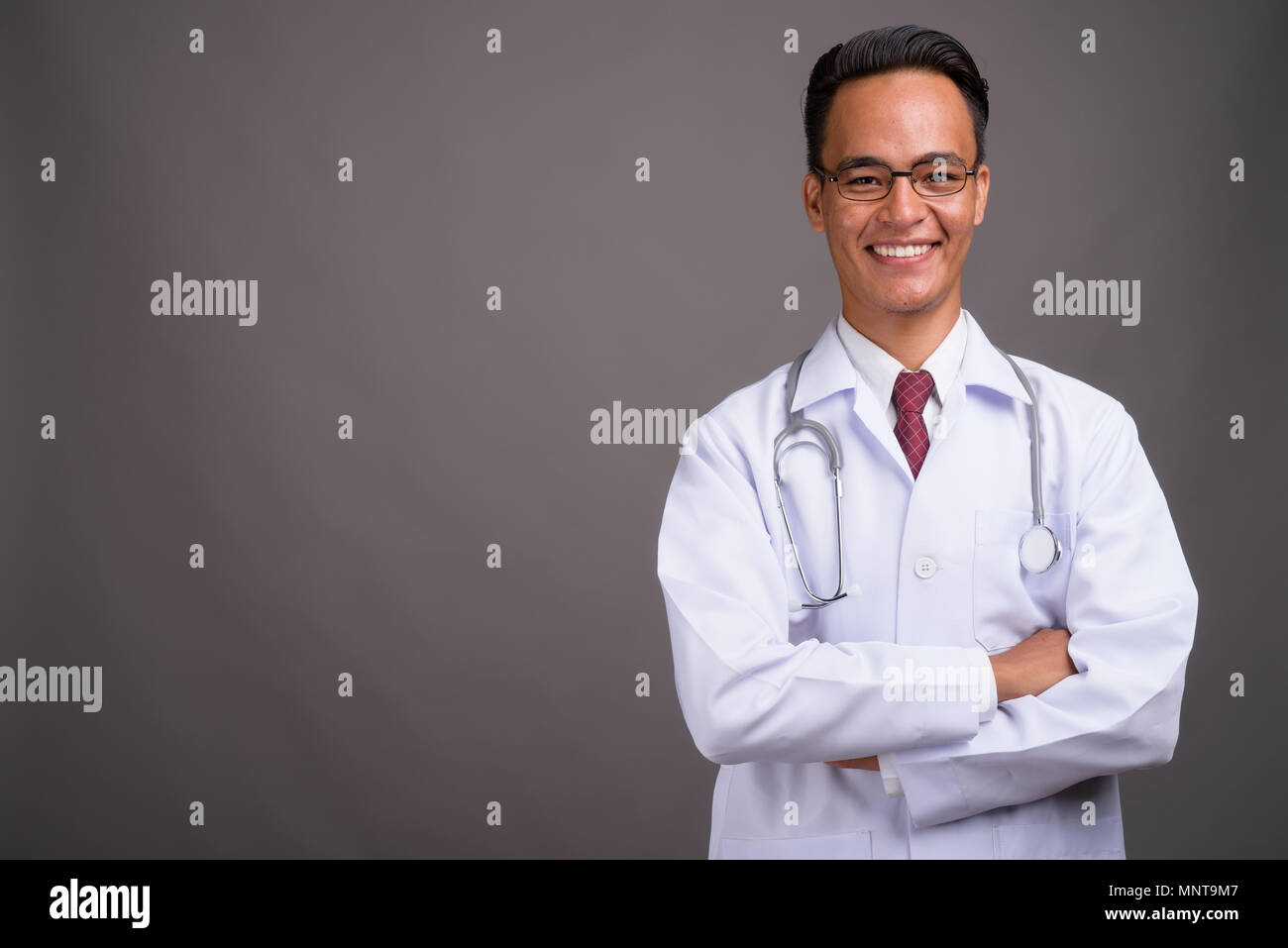 Confident indian doctor smiling hi-res stock photography and images - Alamy