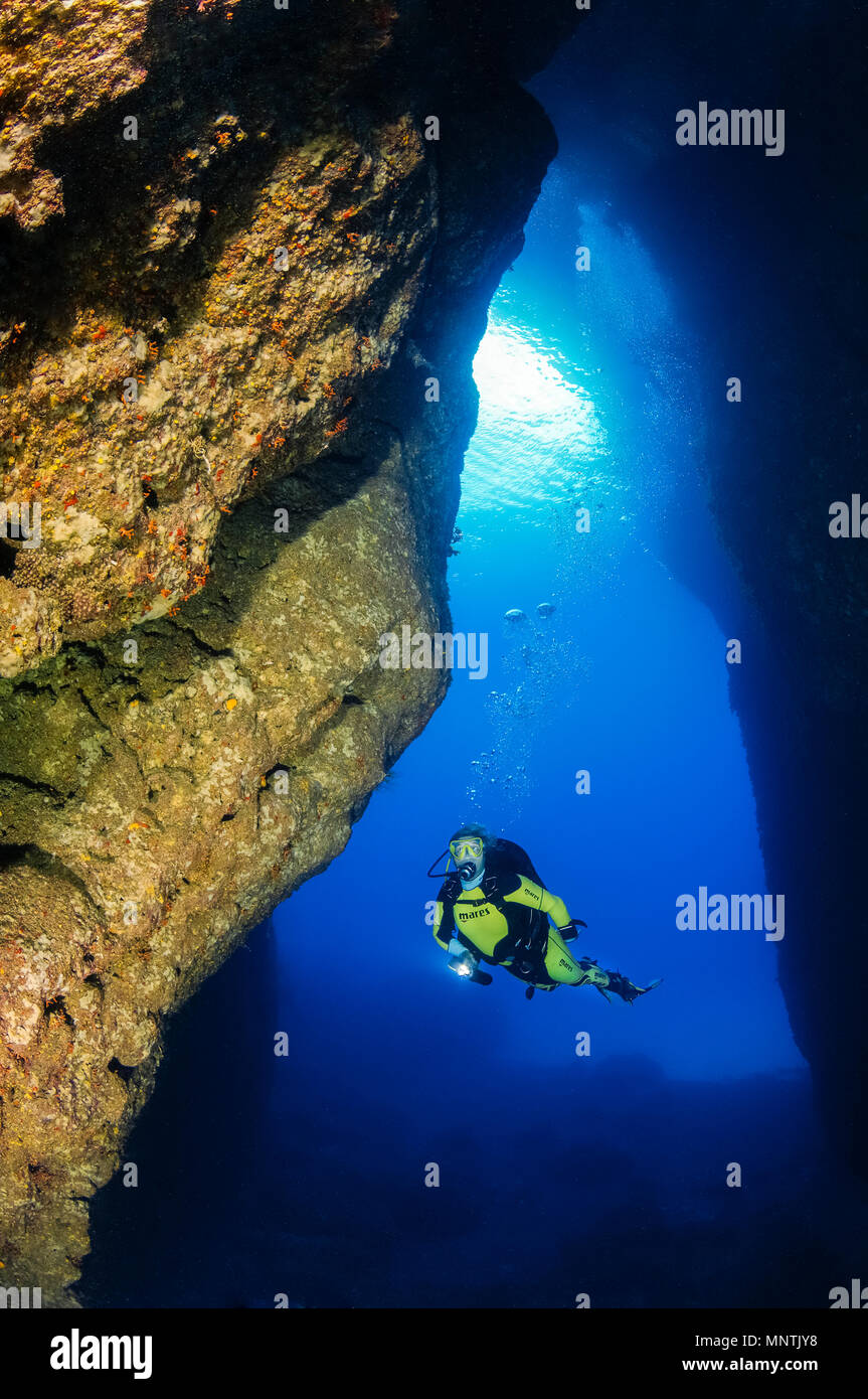 woman scuba diver, exploring Comino Caves, or Santa Marija Caves, Comino, Gozo, Malta, Mediterranean Sea, Atlantic Ocean, MR Stock Photo