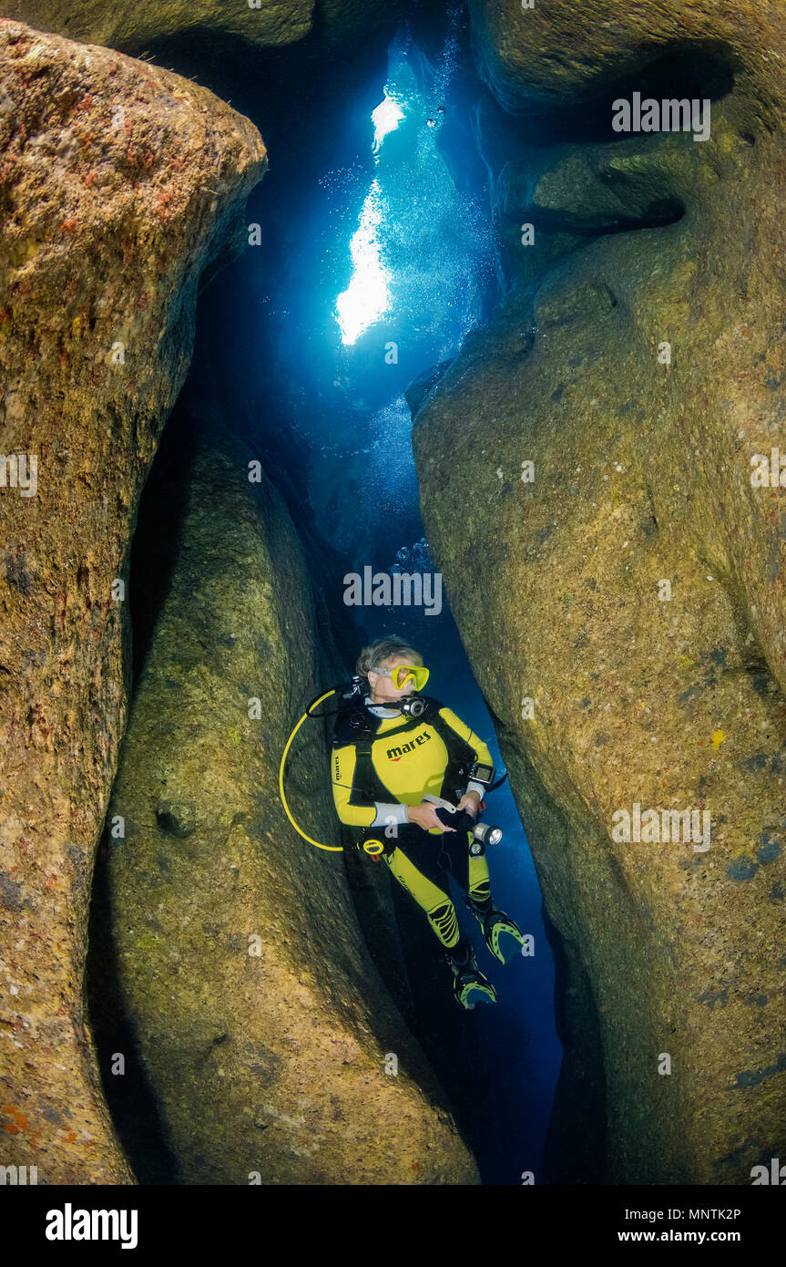 woman scuba diver, exploring Comino Caves, or Santa Marija Caves, Comino, Gozo, Malta, Mediterranean Sea, Atlantic Ocean, MR Stock Photo