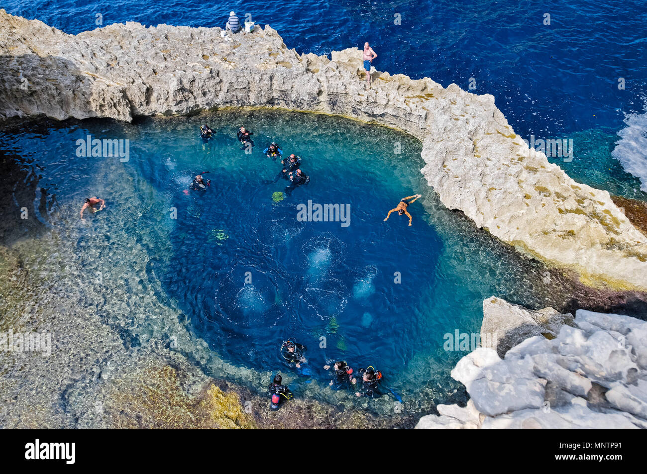 scuba divers and swimmers at Blue Hole, Gozo, Malta, Mediterranean Sea, Atlantic Ocean Stock Photo