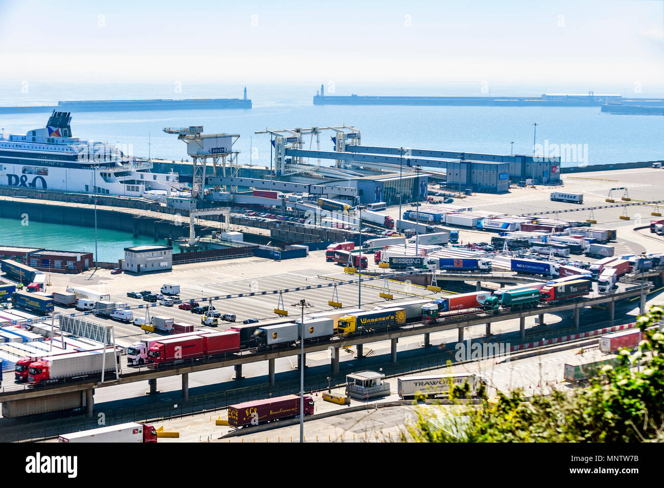 Queue of lorries disembarking and queuing to leave the port of Dover UK Stock Photo
