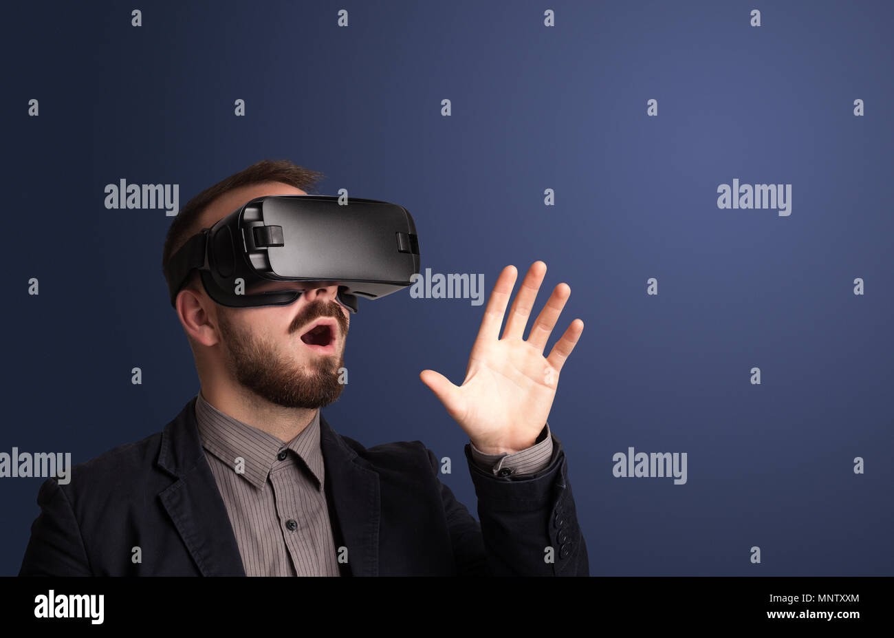 Amazed businessman with virtual reality goggles Stock Photo - Alamy