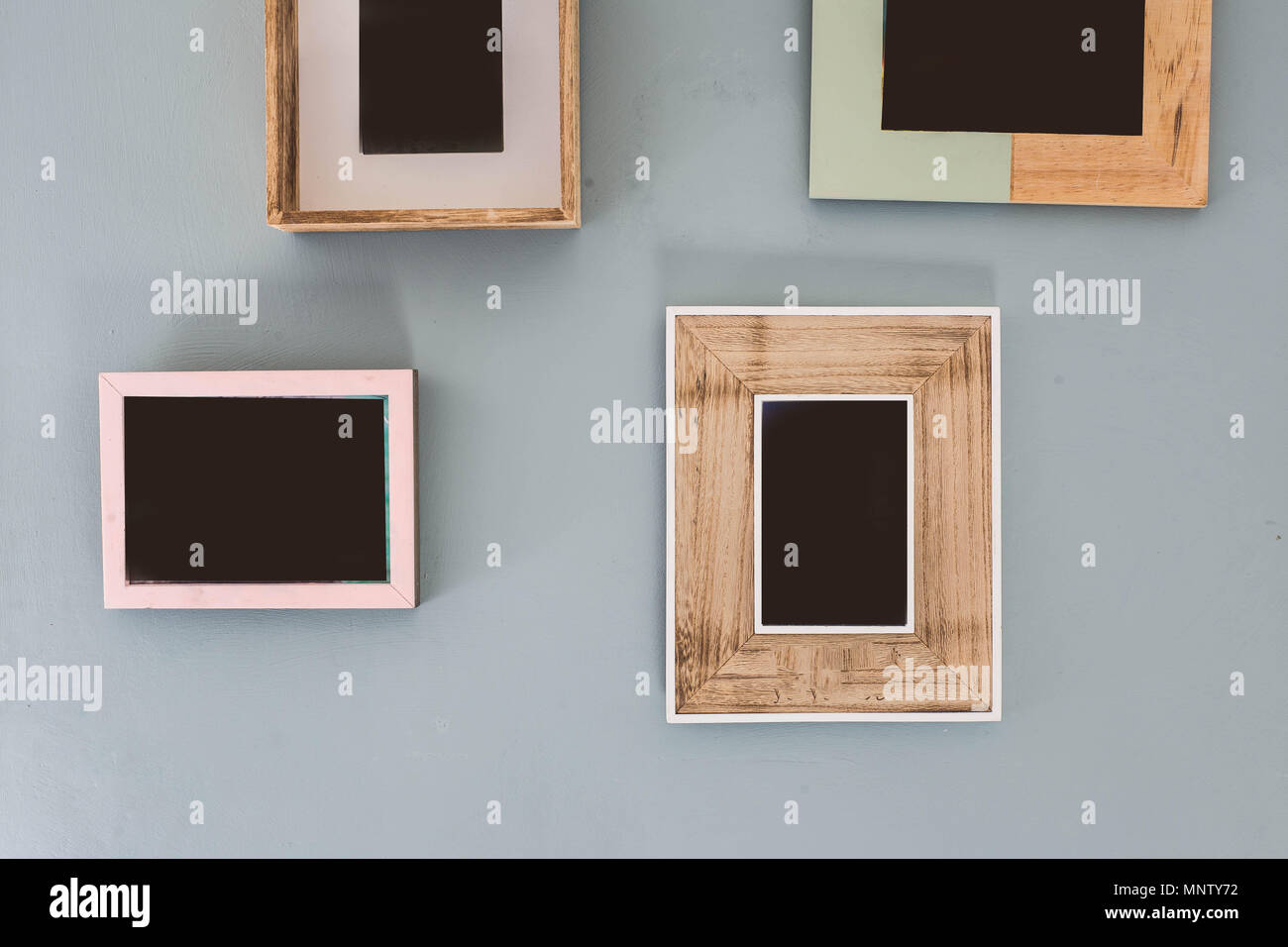 Multiple many blank small picture frames on colorful wall Stock Photo Alamy