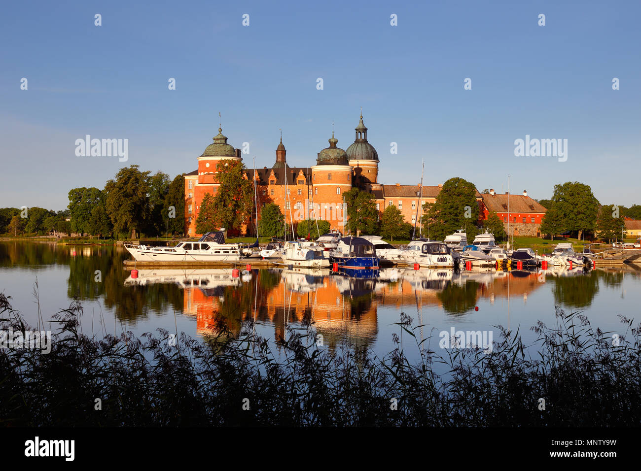 Mariefred, Sweden - August 15, 2017: Morning light with recreational boats in front of the royal Gripsholm Castle, built in the 16th century, is a tou Stock Photo