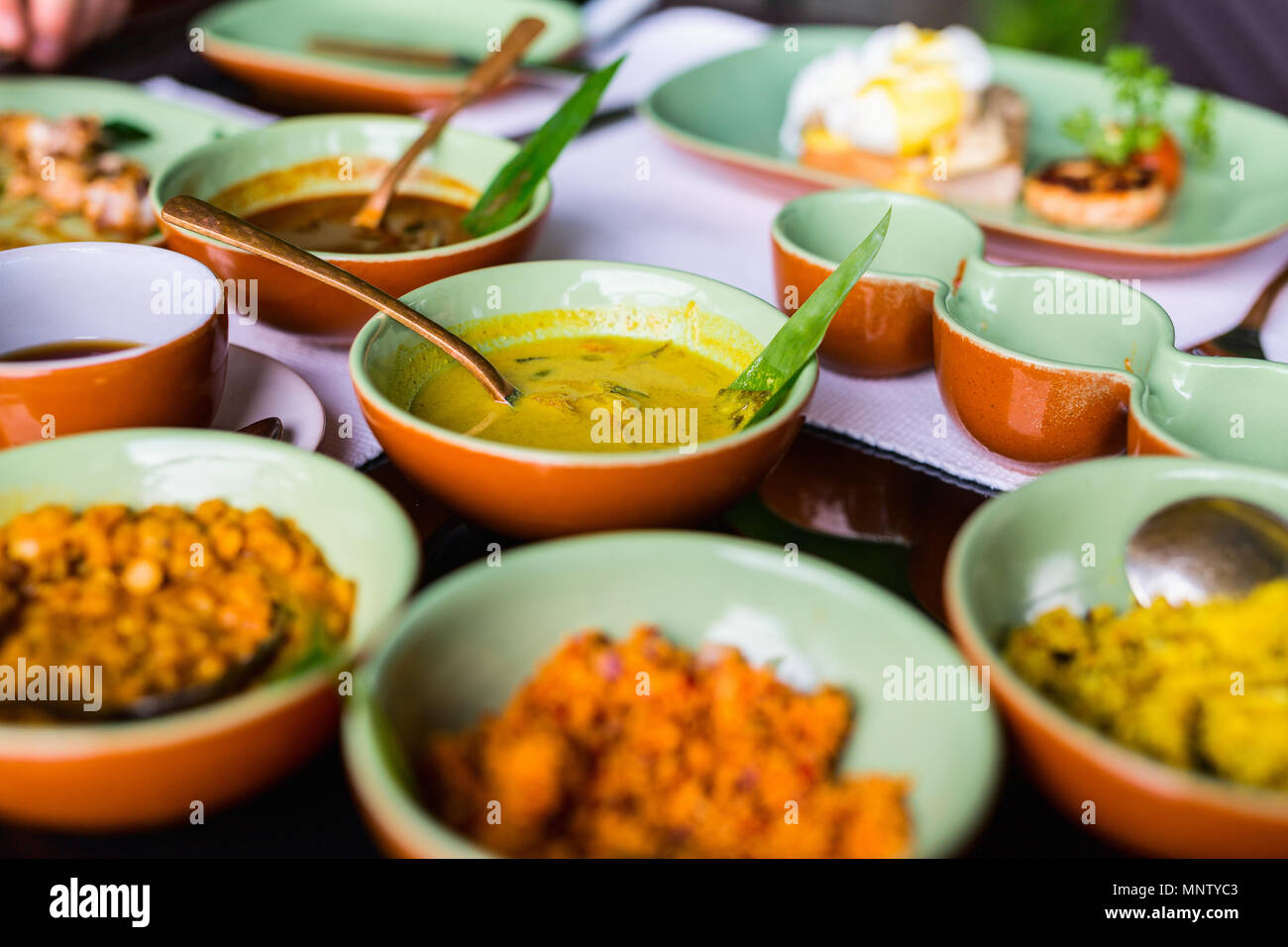Variety of Sri Lankan curry in bowls on table Stock Photo Alamy