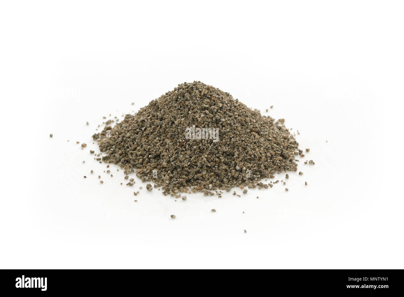 Vermiculite granules, soil amendment mineral used in horticulture and gardening. Closeup of an isolated cone pile on white studio background. Stock Photo