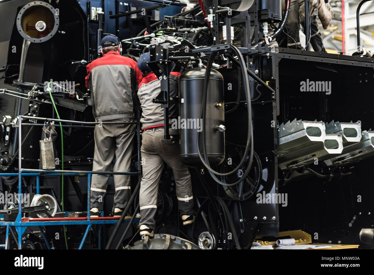 Industrial workers assemble agricultural equipment Stock Photo Alamy